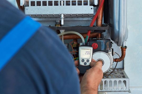 Plumber repairing a boiler