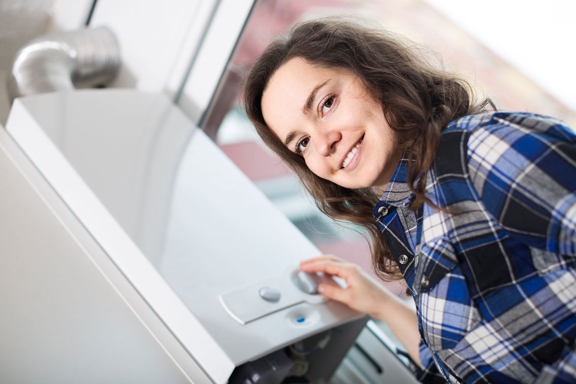 A home owner with her recently fixed boiler